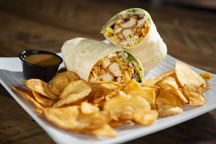 Crispy Chicken, coleslaw mix, romaine lettuce, crispy wonton strips topped with sesame dressing all wrapped up in a warm tortilla served with peanut sauce on the side. Served with a side of chips.