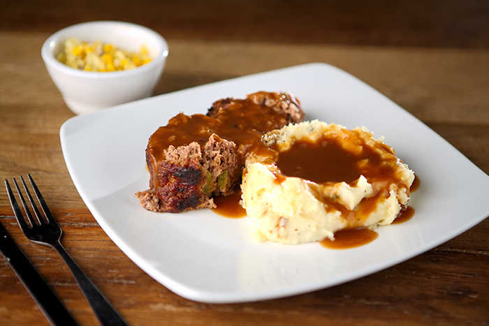 Chef Michael’s homemade meatloaf, served with creamy mashed potatoes, rich gravy, and a seasonal veggie.